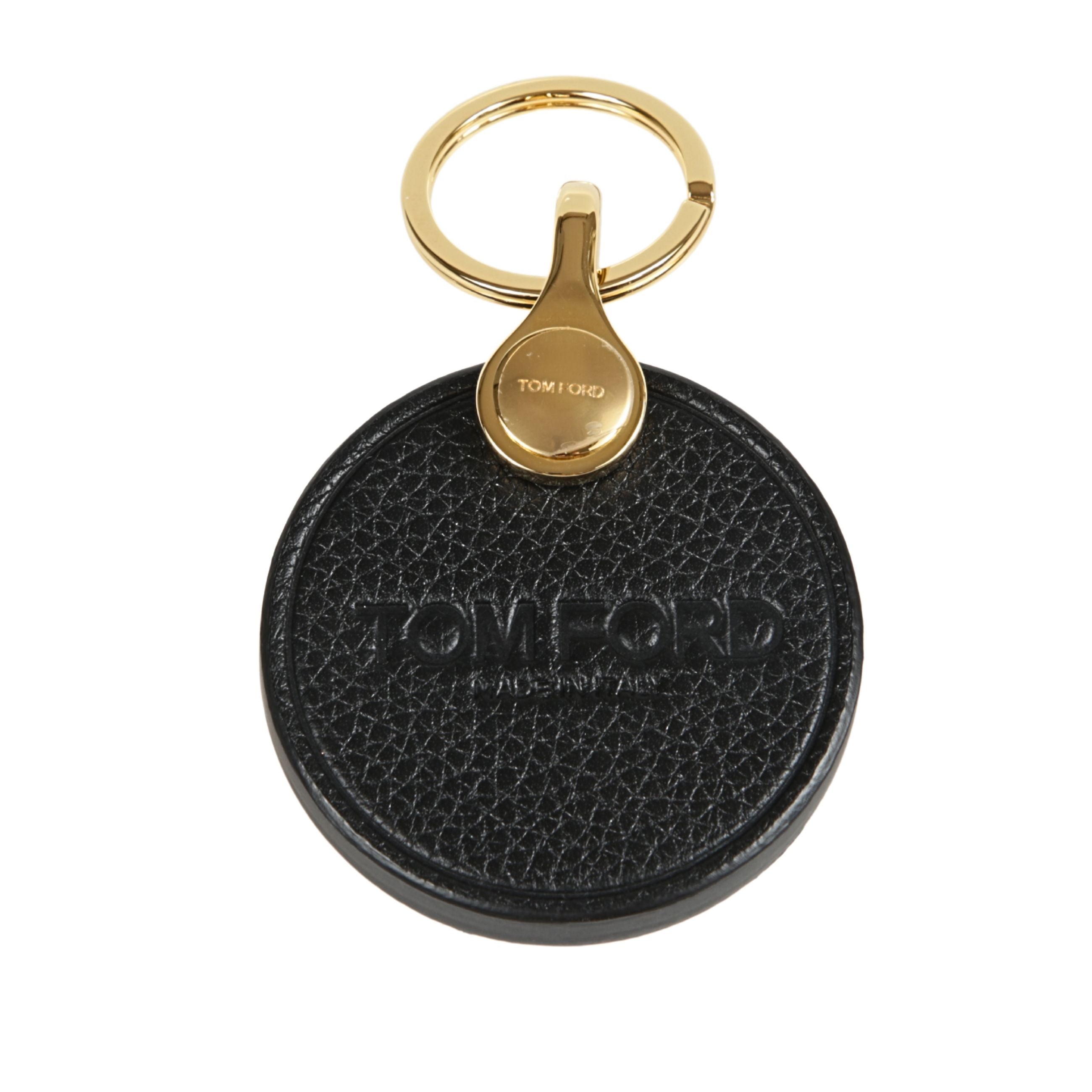 Portachiavi in pelle a forma circolare, con logo inciso e dettagli in oro.