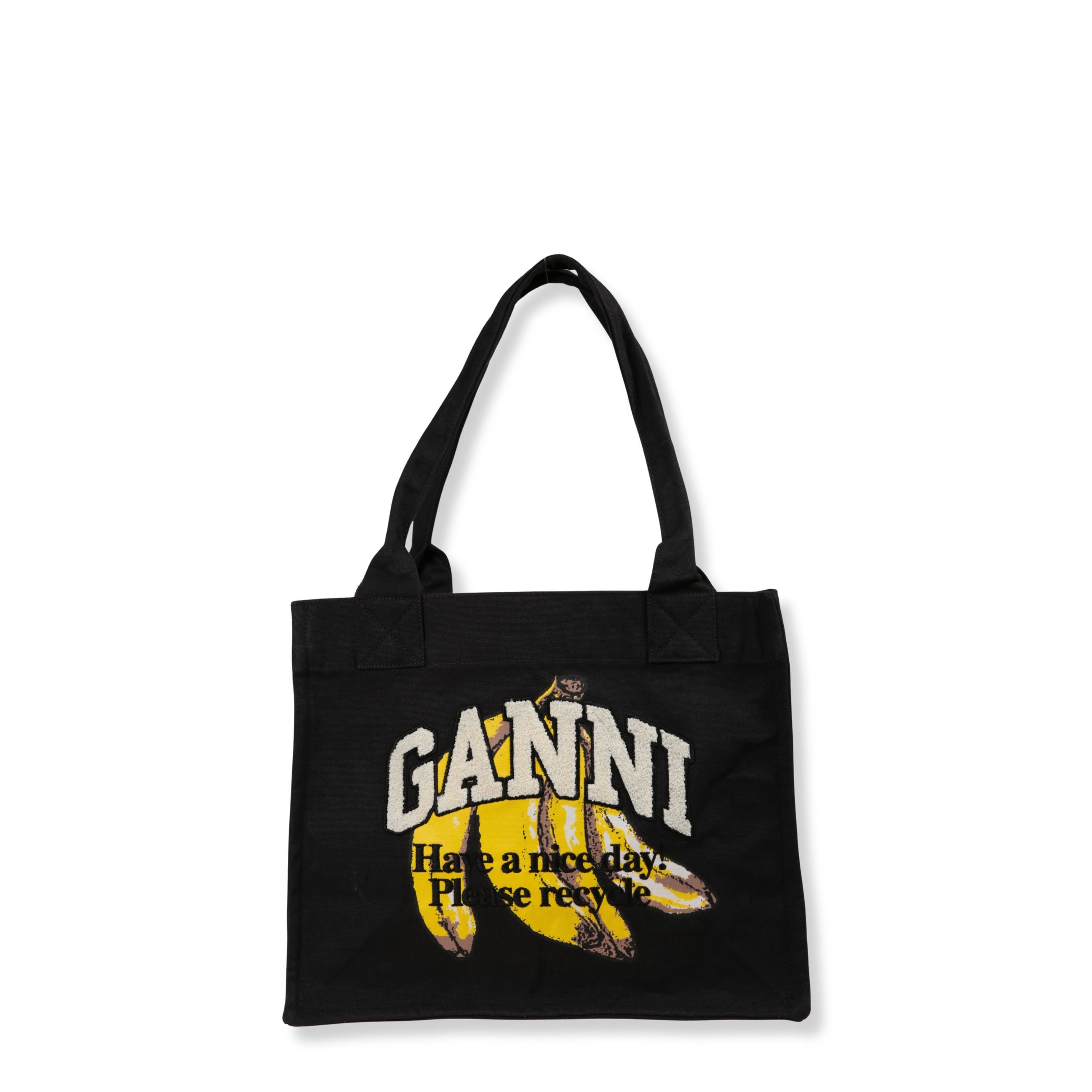 Borsa a mano ganni in tela. formato shopper bag con doppi manici superiori. tinta unita con stampa sul fronte.
