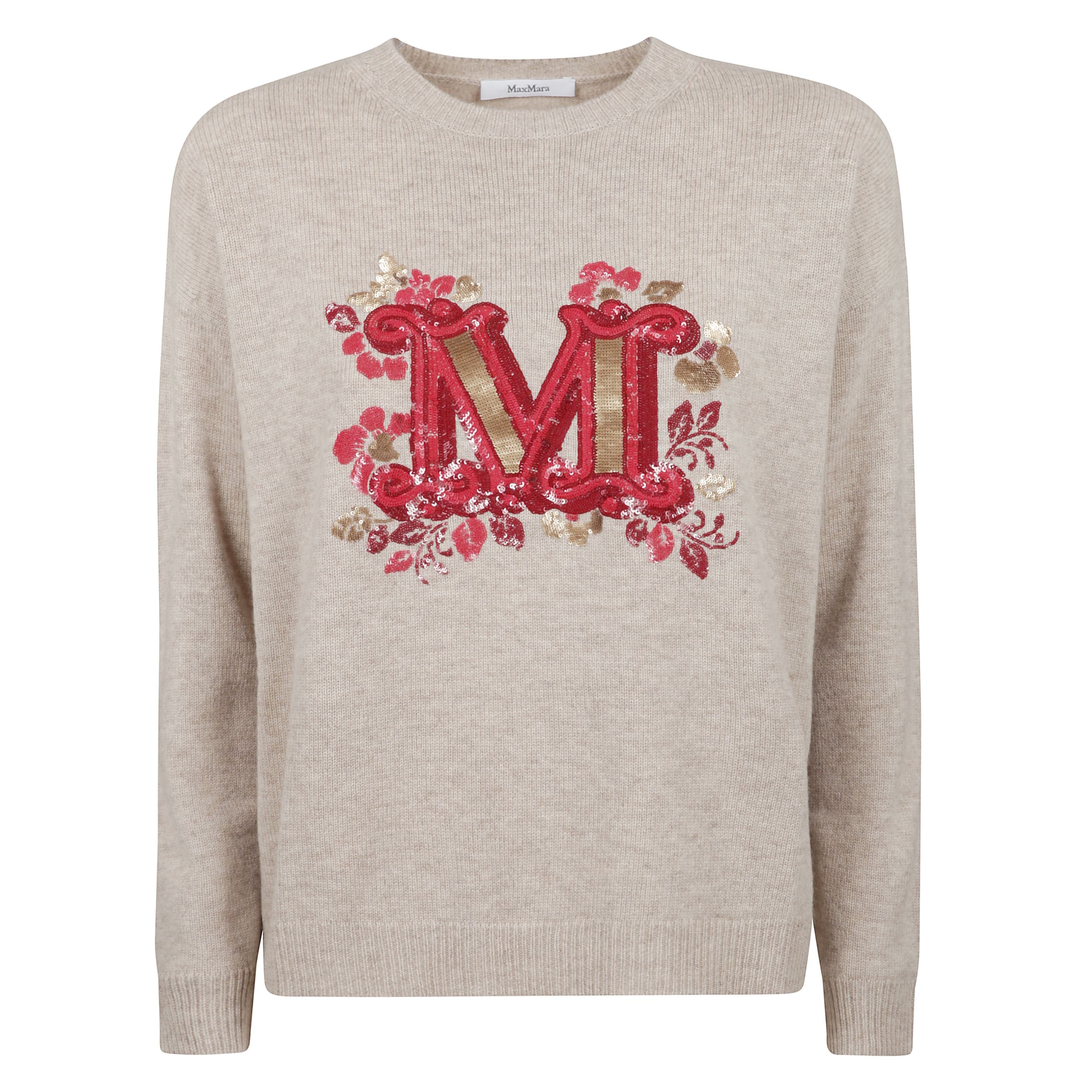 Maglia girocollo in pregiato filato rasato di lana e cachemire.
motivo m monogram ricamato sul davanti in paillette. modello dal volume leggermente oversize con maniche lunghe a giro basso e bordi a costine.