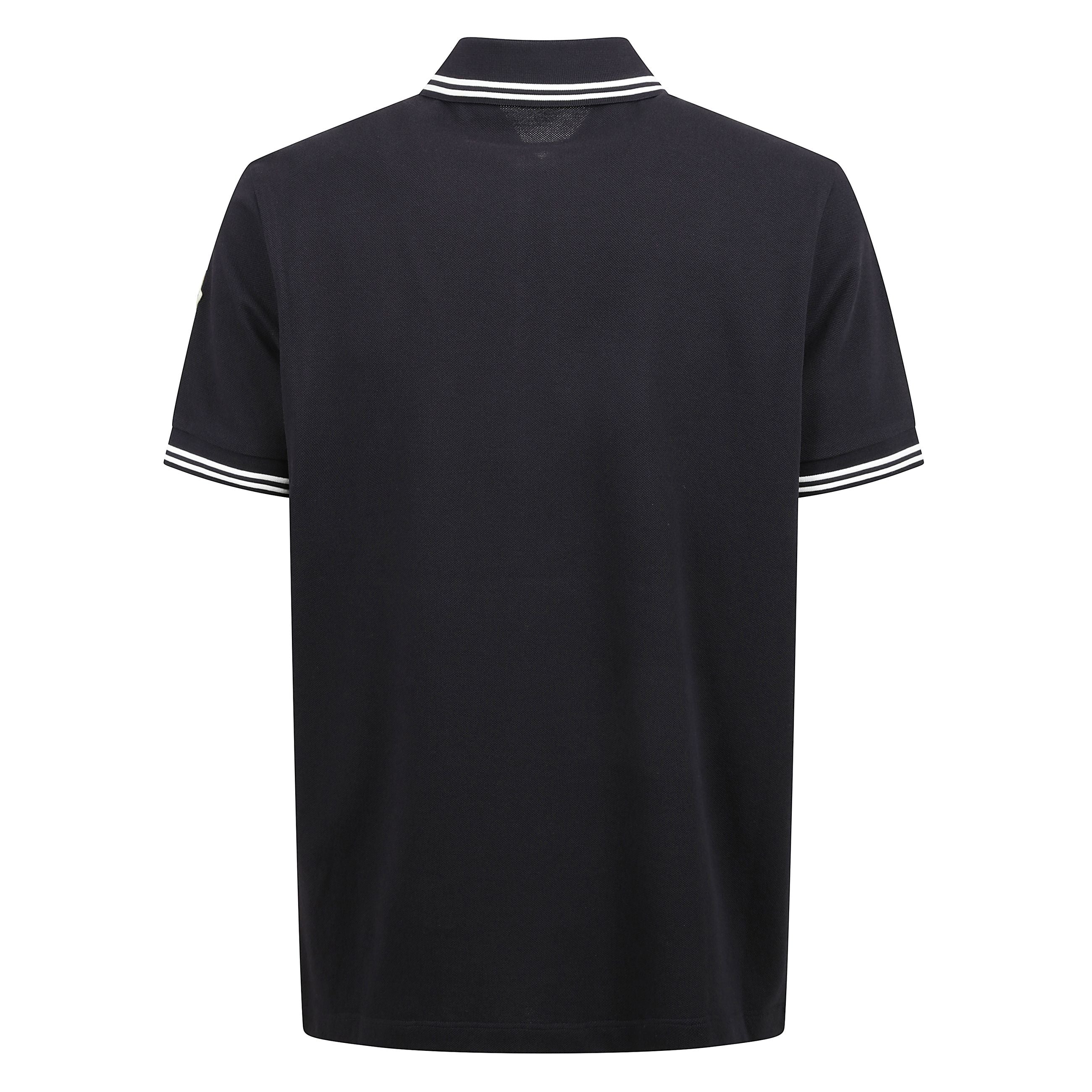 Polo in cotone piquet con orlo a righe