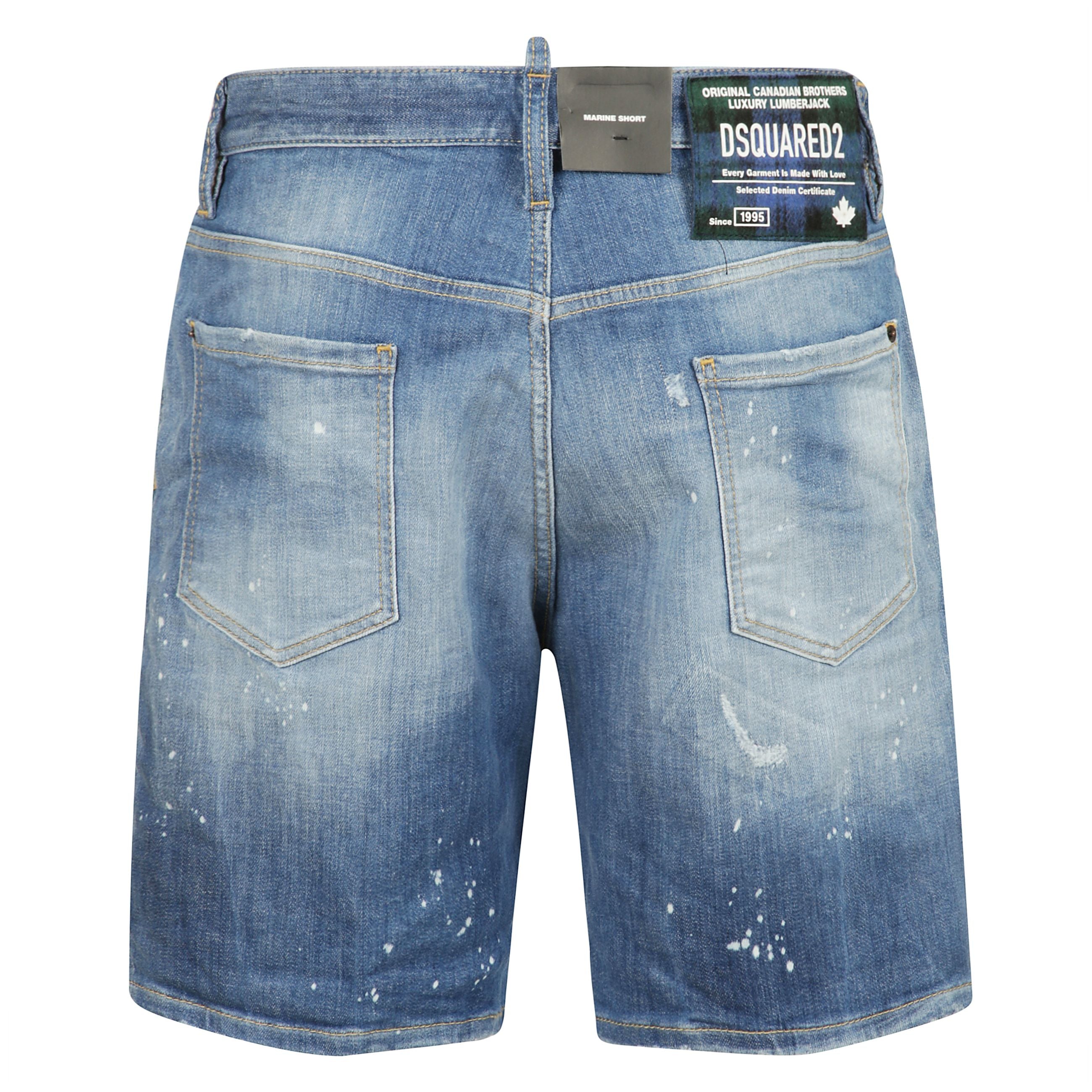 Un'icona di stile casual-chic, questi bermuda in denim firmati dsquared2 sono il mix perfetto tra carattere urbano e artigianalità di lusso. realizzati in cotone premium, presentano un trattamento stonewashed con effetti destroyed e schizzi di vernice, p