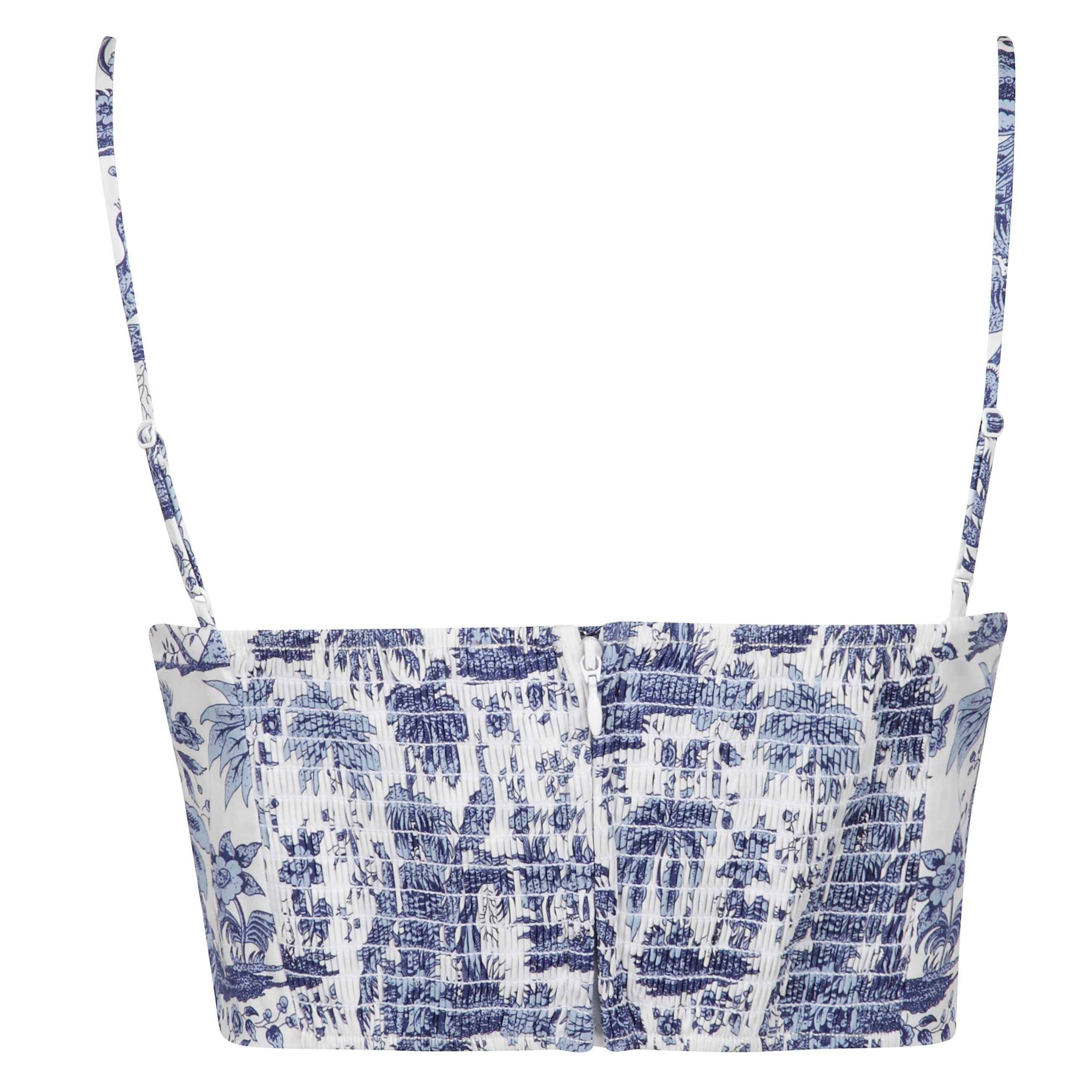 Top bianco con chiusura posteriore a zip nascosta
e spalline sottili regolabili