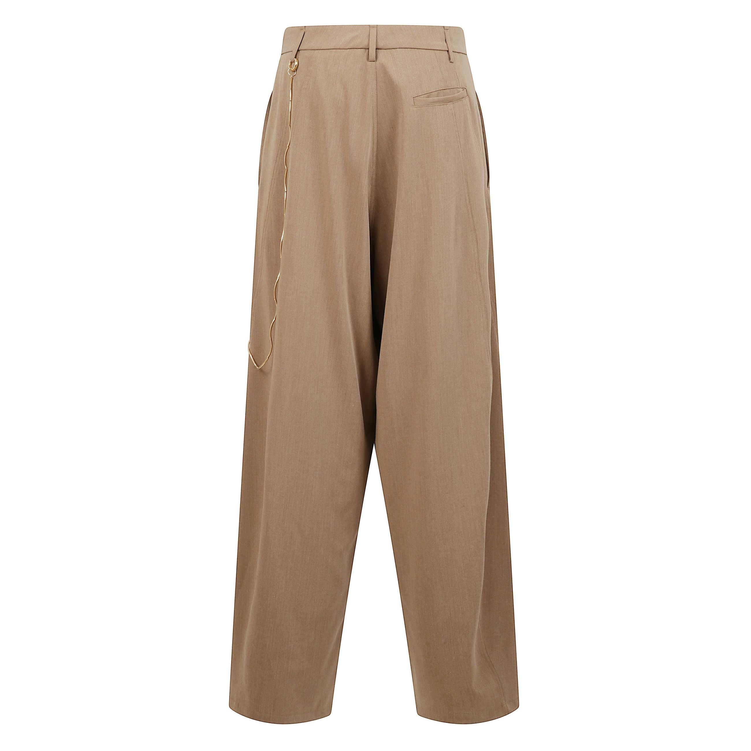 Pantalone a vita bassa con pince frontali e vestibilità rilassata. chiusura con zip e bottone e passanti per cintura. due tasche a filetto laterali, una tasca a filetto sul retro. accessorio catena rimovibile color oro applicata sul lato.
