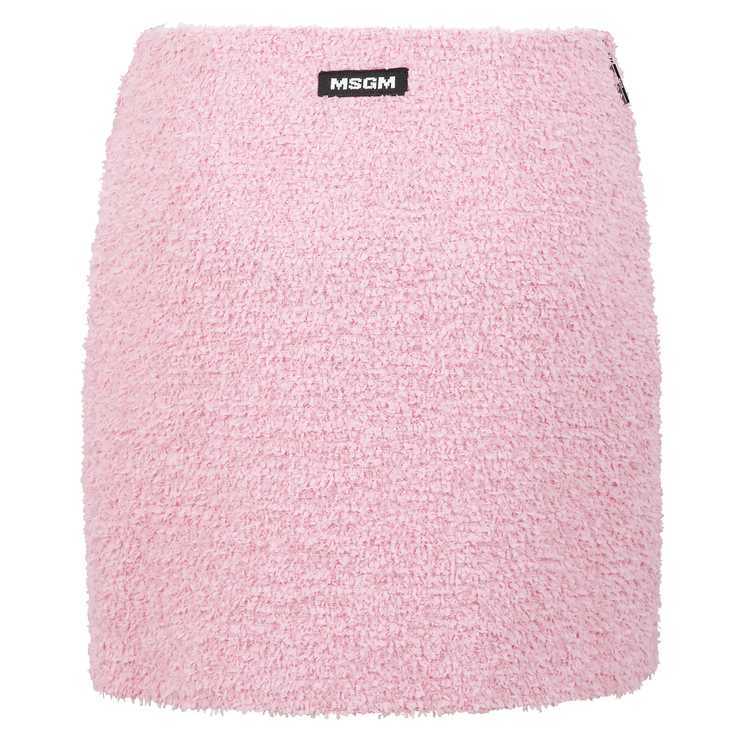 Gonna corta in tweed effetto spugna tinta unita caratterizzata da una costruzione a finto portafoglio con incrocio sul davanti. chiusura con zip sul fianco. label msgm cucita sul retro.