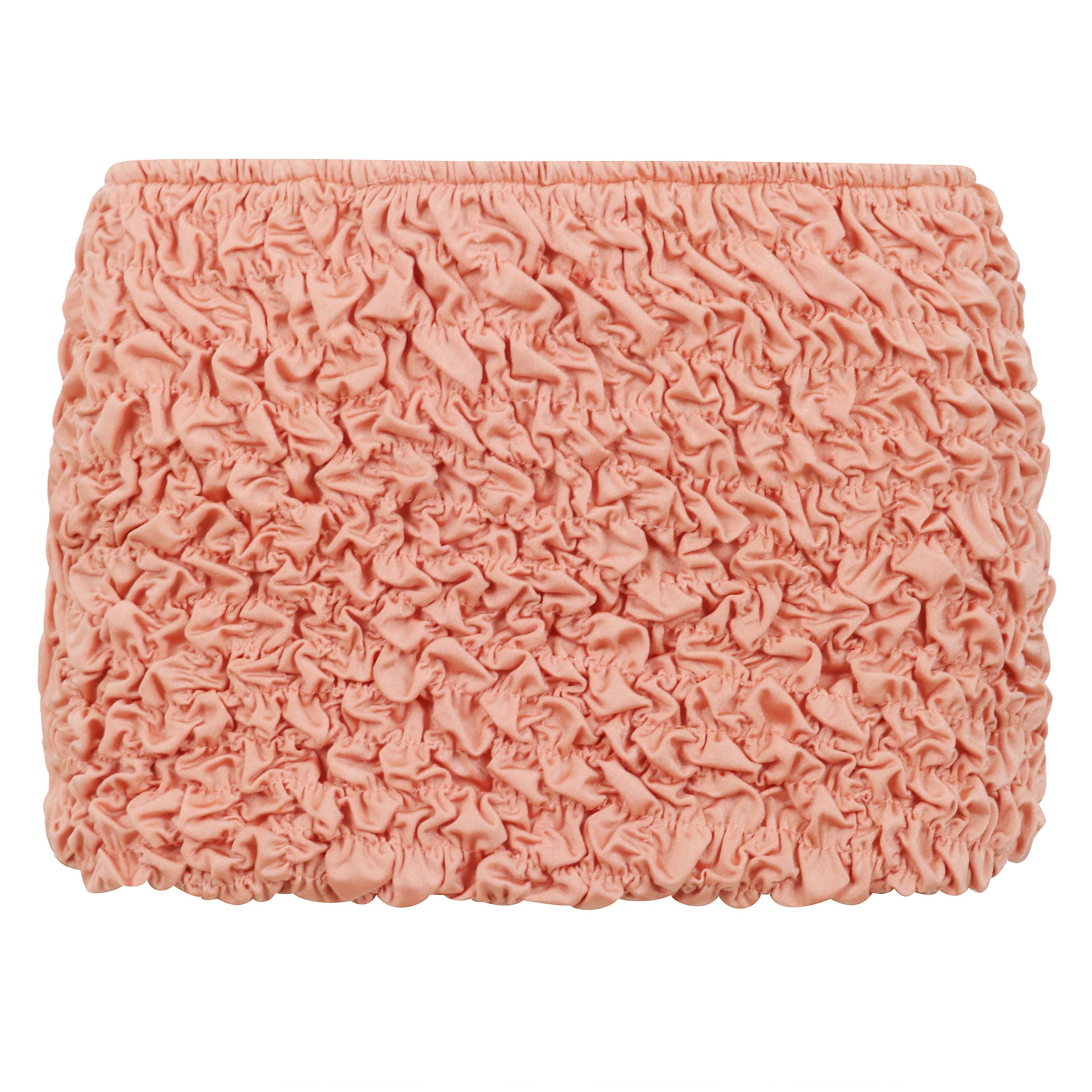 La mini gonna da spiaggia lia è realizzata in tessuto shirring per un drappo perfettamente lussuoso.