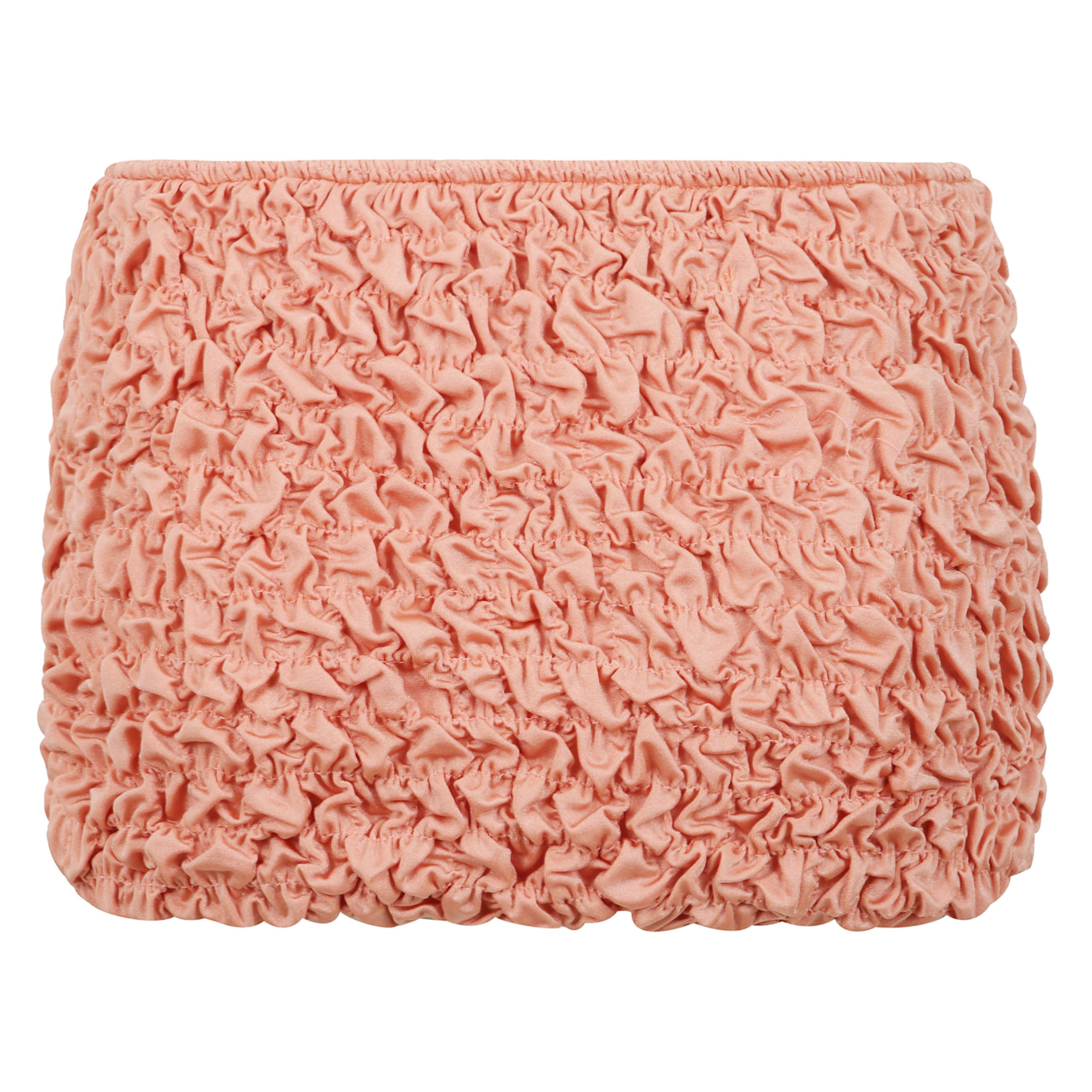 La mini gonna da spiaggia lia è realizzata in tessuto shirring per un drappo perfettamente lussuoso.