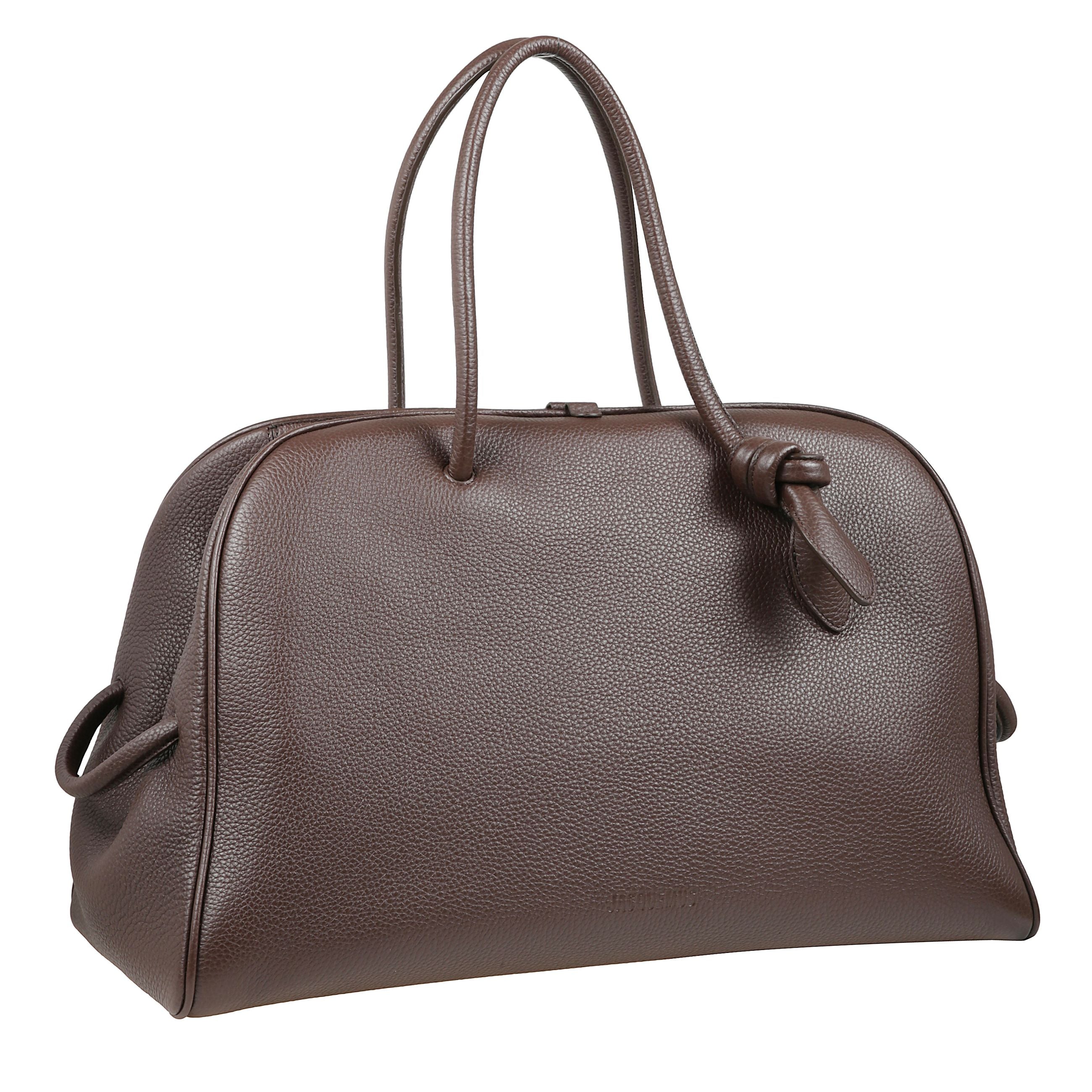 Borsa in pelle martellata. doppi manici superiori. chiusura con zip nascosta. due piccoli passanti decorativi laterali.