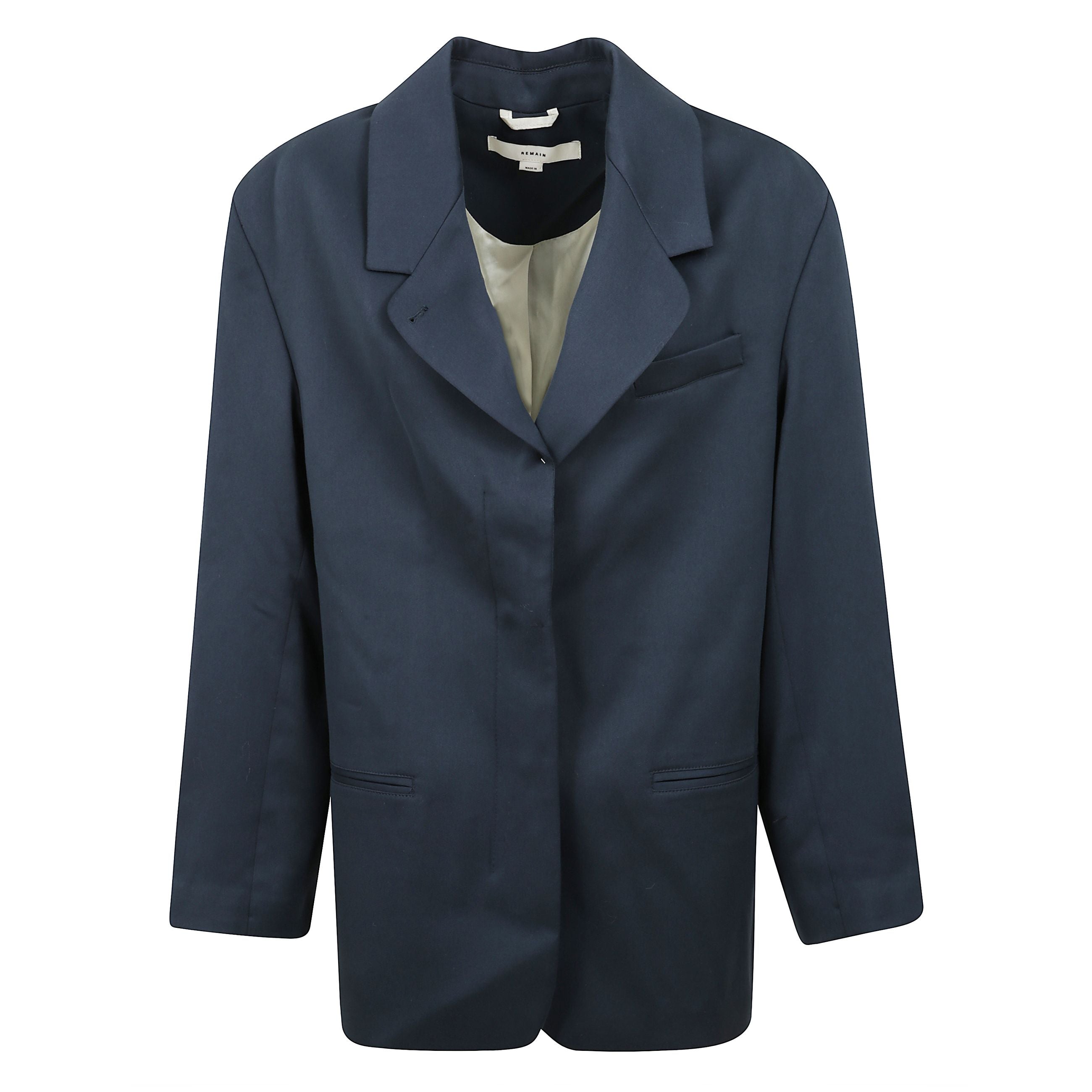 Blazer oversize con spalline, chiusura doppiopetto con bottoni, tasca a filetto sul petto e due tasche a filetto frontali