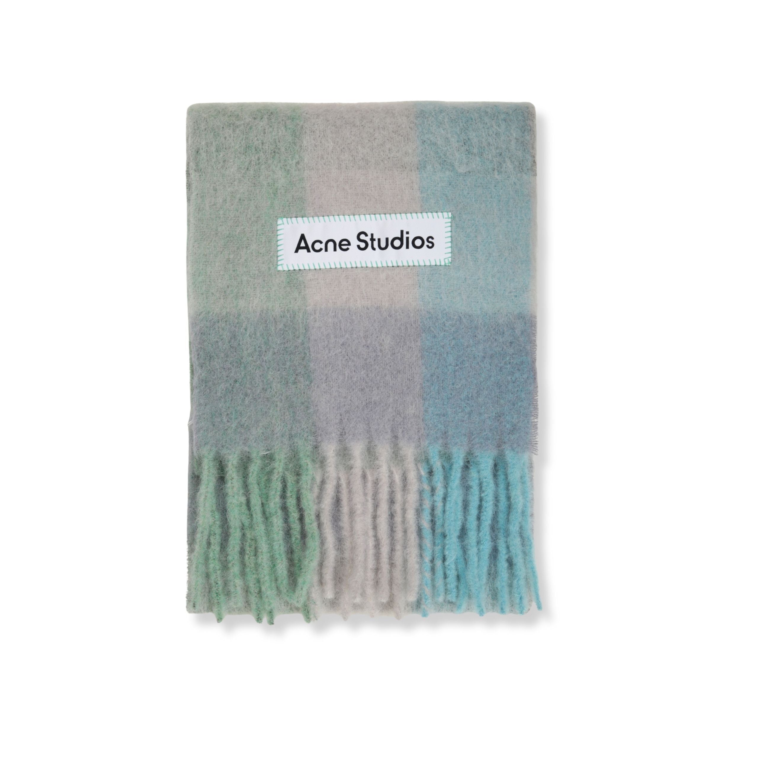 Sciarpa in lana acne studios. motivo a quadri. orlo con frange. logo del brand applicato.