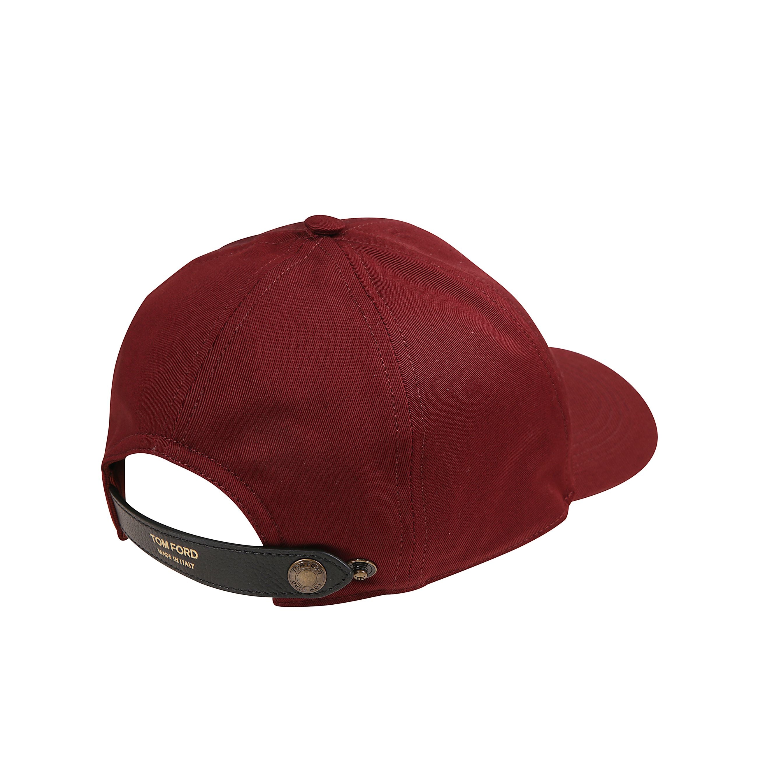 Cappello da baseball in cotone con interno foderato. ricamo frontale a contrasto con le monogramma tf. cinturino regolabile in pelle con firma del brand tom ford laminata.