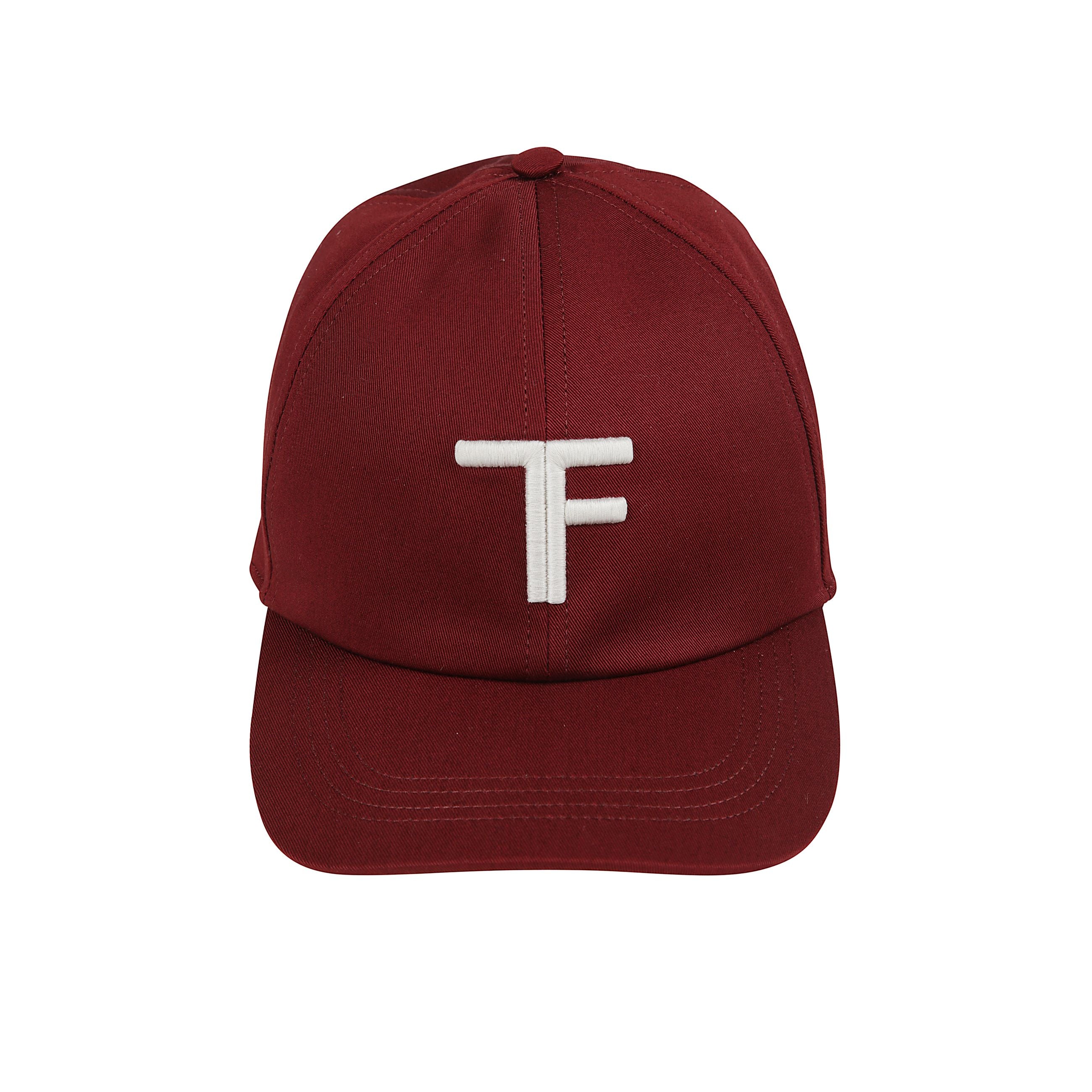 Cappello da baseball in cotone con interno foderato. ricamo frontale a contrasto con le monogramma tf. cinturino regolabile in pelle con firma del brand tom ford laminata.