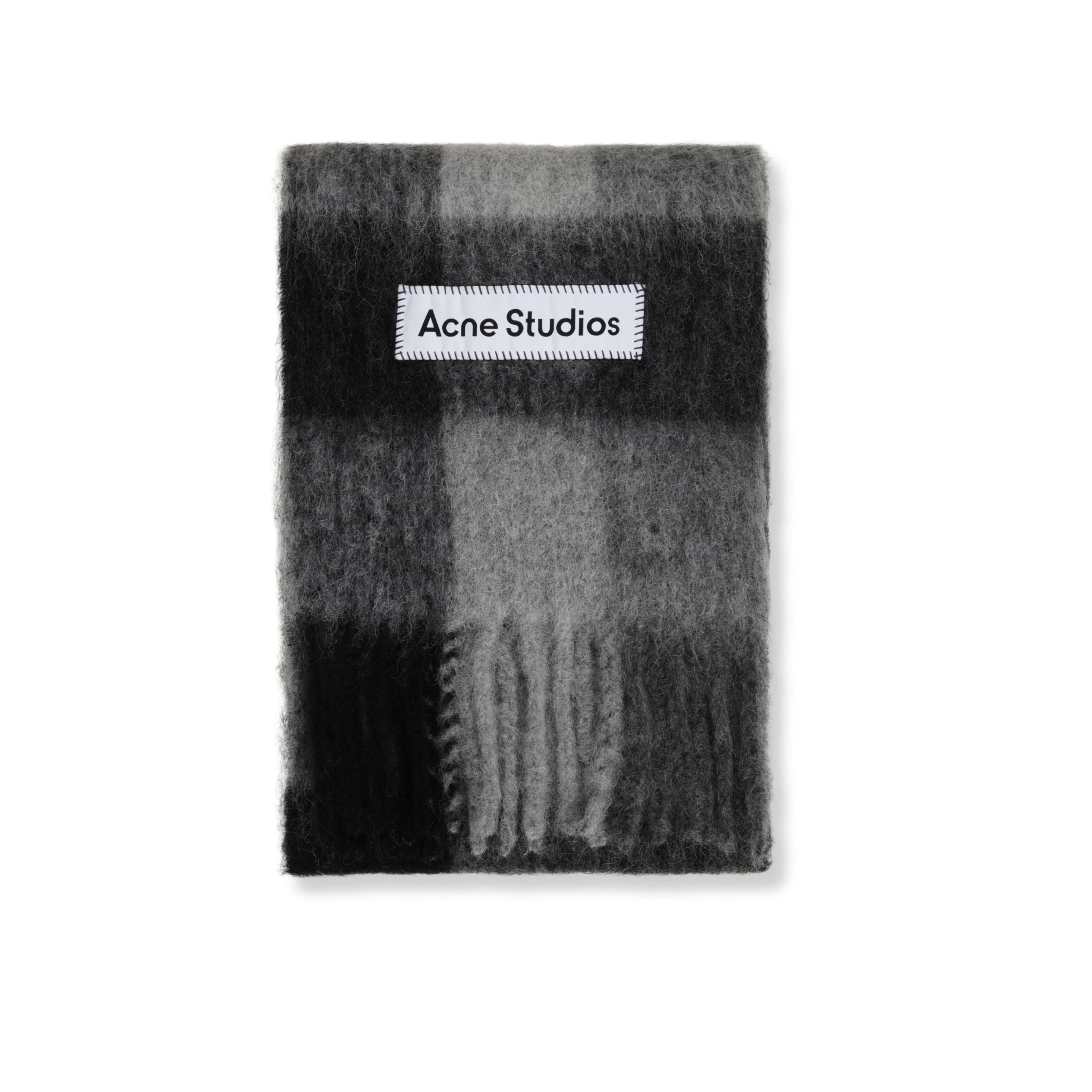 Sciarpa in lana acne studios. motivo a quadri. orlo con frange. logo del brand applicato.