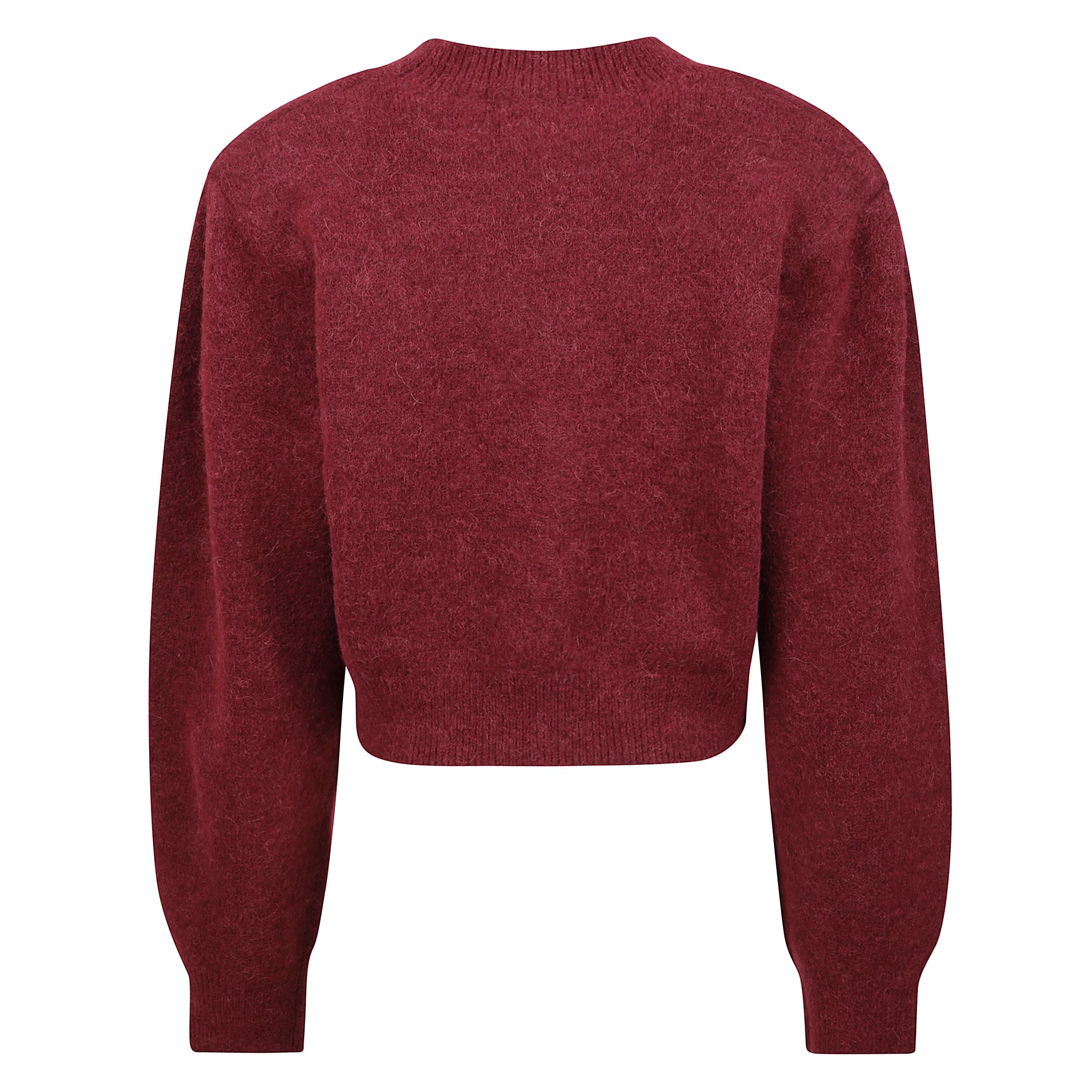 Cardigan in maglia con maniche a sbuffo e scollatura a v. silhouette corta con polsini aderenti e orlo a coste. spalle arricciate e spalline removibili. decorazione in maglia rosa rimovibile al centro davanti.