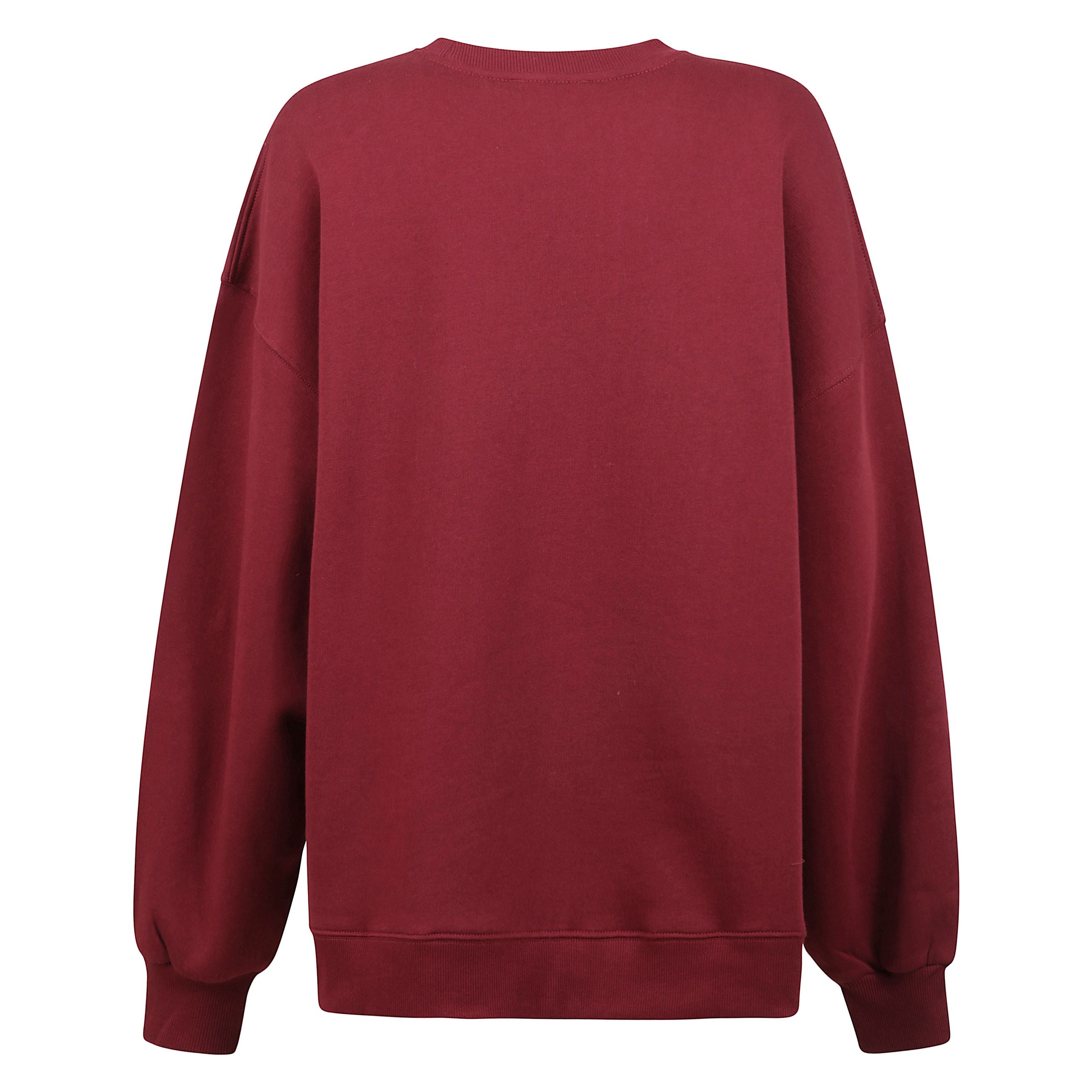 Felpa oversize in cotone biologico, realizzata in maglia fine elasticizzata con interno delicatamente imbottito. il design presenta girocollo classico, spalle abbassate e finiture a costine su polsi e orlo. completata dal logo ricamato sul petto per un to